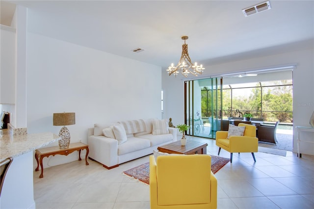 tiled living room featuring an inviting chandelier