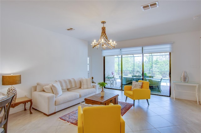 tiled living room with a notable chandelier