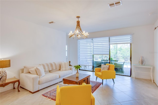 living room featuring a notable chandelier and light tile patterned floors