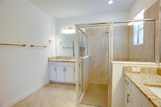 bathroom featuring vanity, tile patterned flooring, and a shower with door