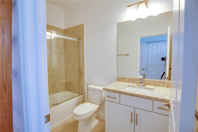 full bathroom featuring tile patterned floors, bath / shower combo with glass door, vanity, and toilet