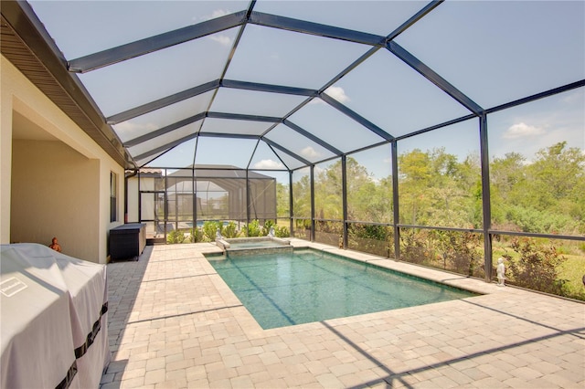 view of pool featuring a patio and glass enclosure