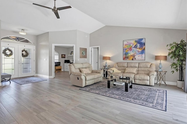 living room with french doors, ceiling fan, high vaulted ceiling, and light wood-type flooring