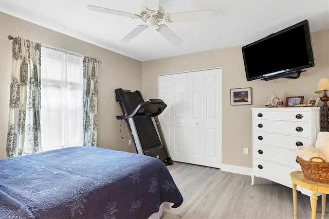 bedroom with a closet, ceiling fan, and light wood-type flooring