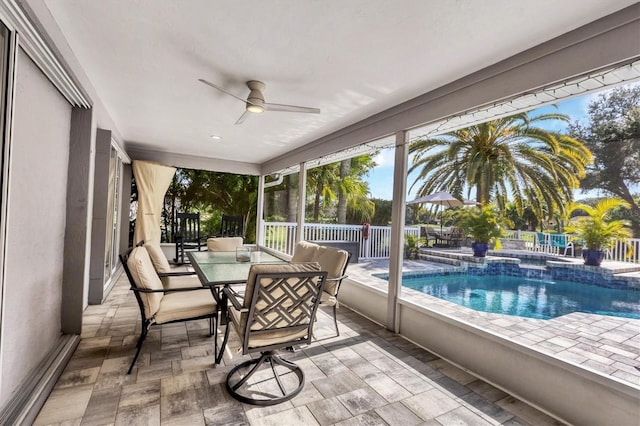 sunroom featuring ceiling fan