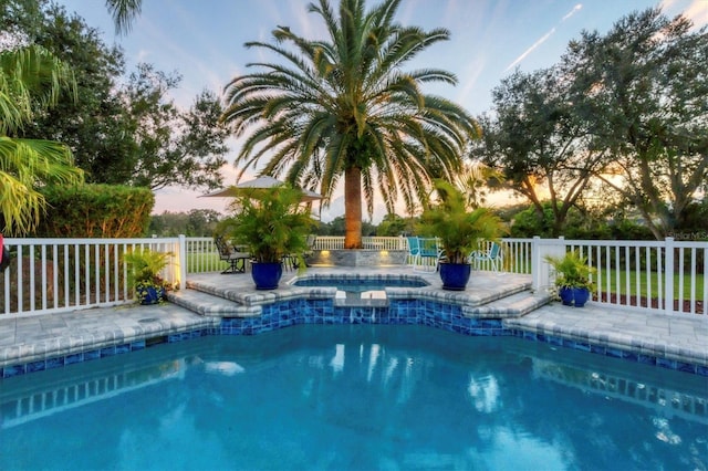 view of pool at dusk