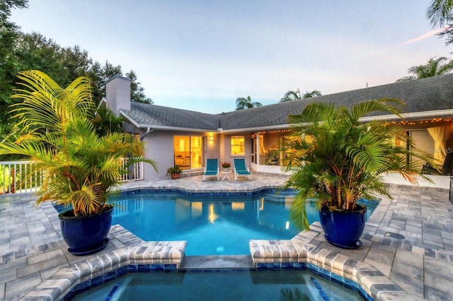 view of swimming pool with a patio and an in ground hot tub