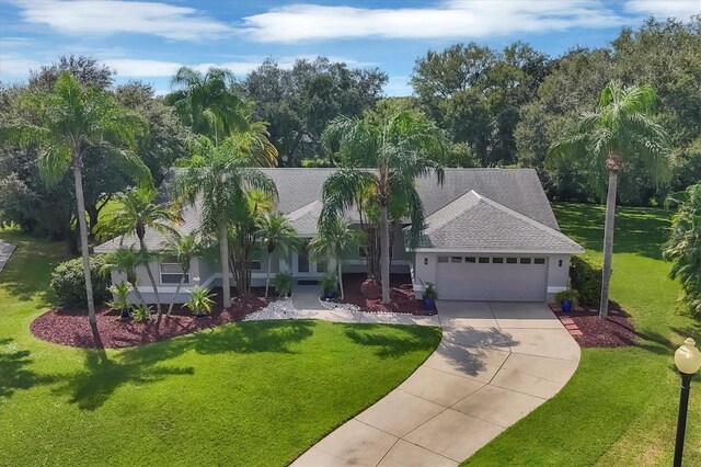 view of front of property featuring a front yard and a garage