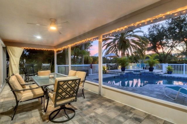 sunroom featuring ceiling fan