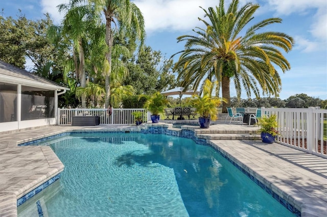 view of pool with a patio and a sunroom