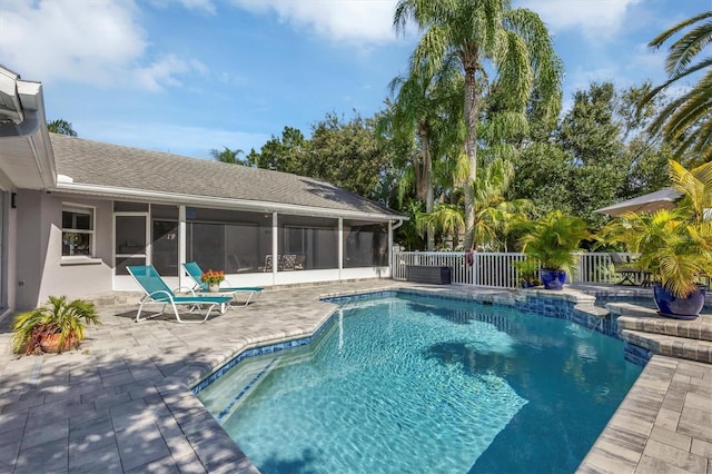 view of pool featuring a sunroom and a patio