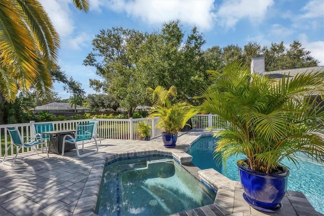 view of swimming pool with an in ground hot tub and a patio