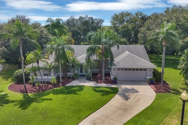 view of front of home with a garage and a front lawn