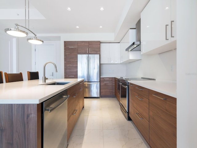 kitchen with white cabinetry, sink, pendant lighting, a center island with sink, and appliances with stainless steel finishes