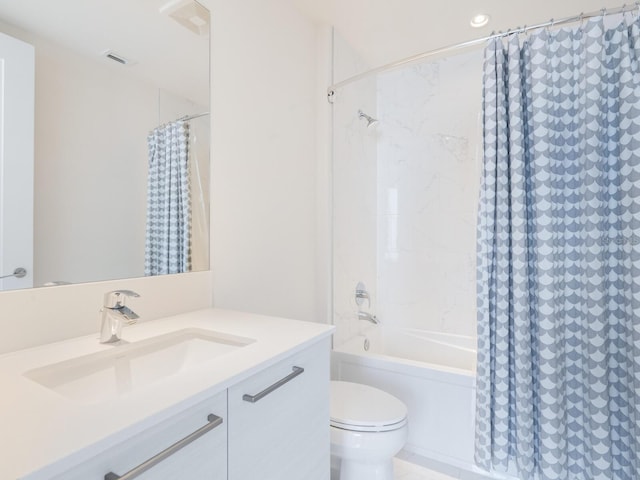 full bathroom with vanity, shower / tub combo, and toilet