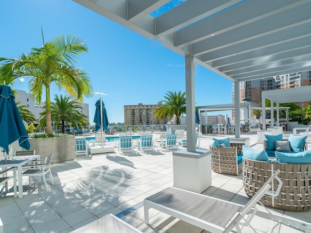 view of patio / terrace with a pergola, a community pool, and an outdoor hangout area