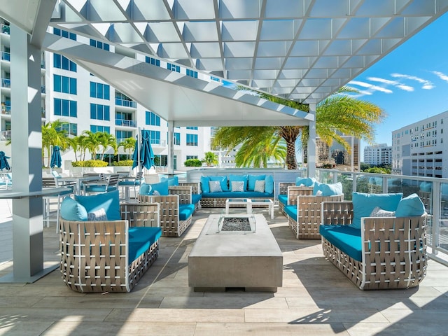 view of patio with a pergola and an outdoor living space with a fire pit