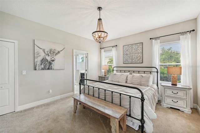 bedroom with an inviting chandelier, multiple windows, and light carpet