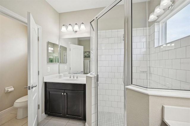 bathroom with vanity, toilet, tile patterned floors, and a shower with shower door