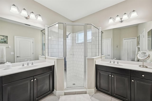 bathroom with walk in shower, tile patterned flooring, and vanity