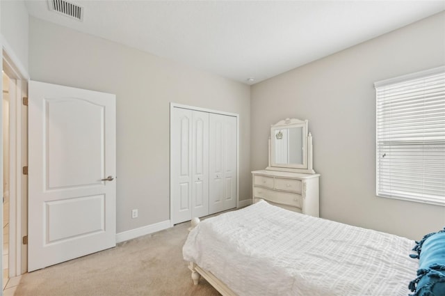 carpeted bedroom featuring a closet