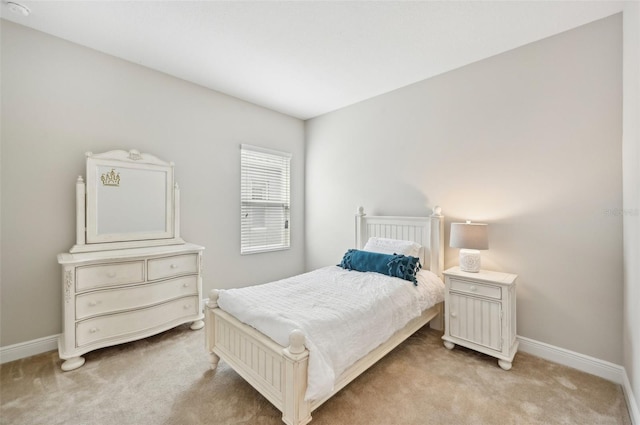 bedroom featuring light carpet