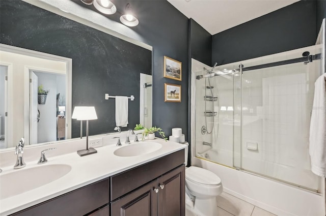 full bathroom with tile patterned flooring, shower / bath combination with glass door, vanity, and toilet