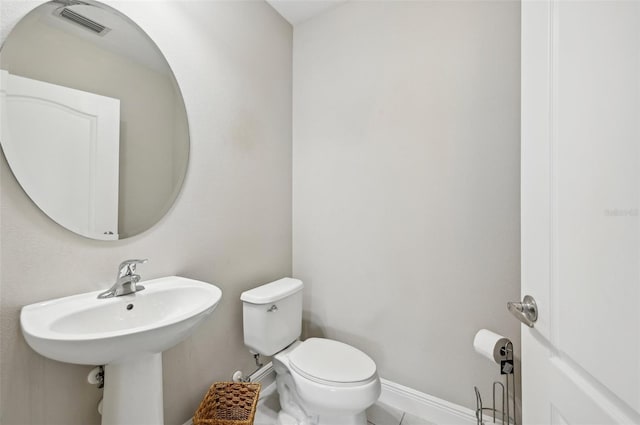 bathroom featuring tile patterned flooring and toilet