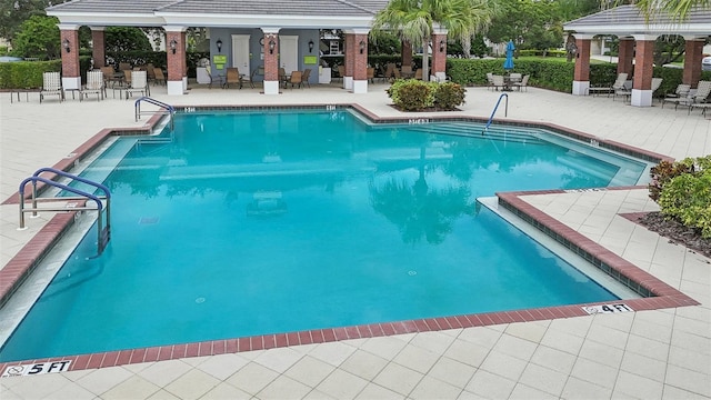 view of swimming pool featuring a patio and a gazebo