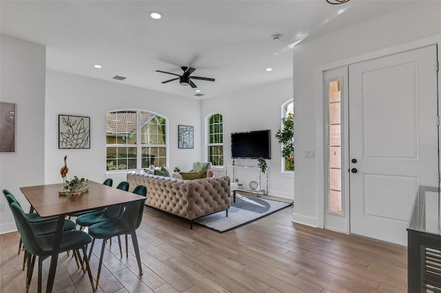 living room with ceiling fan and light hardwood / wood-style flooring