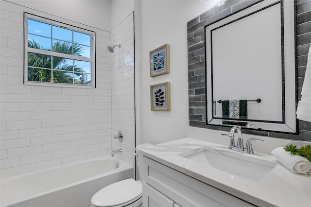 full bathroom with vanity, toilet, and tiled shower / bath combo