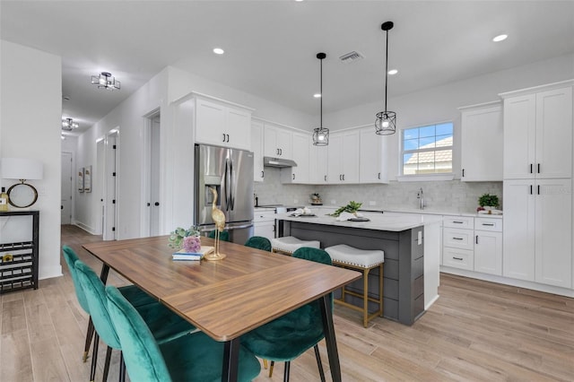 dining room with light wood-type flooring and sink