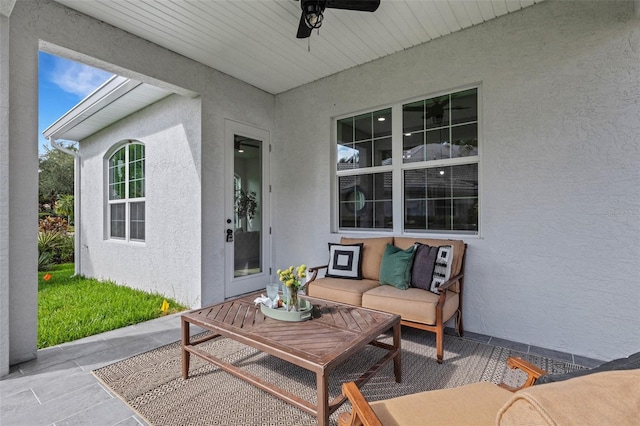 view of patio with ceiling fan and an outdoor living space