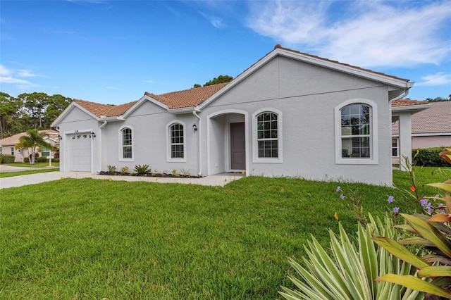 view of front of property with a front lawn and a garage