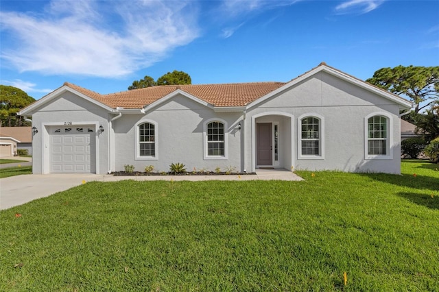 view of front of home with a garage and a front lawn