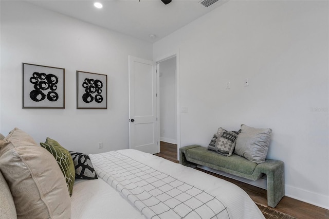 bedroom with ceiling fan and dark hardwood / wood-style floors