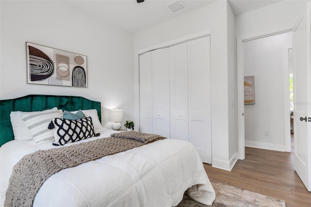 bedroom with wood-type flooring and a closet