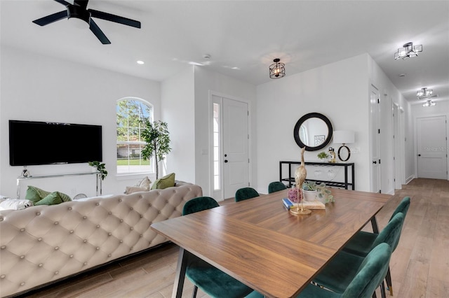 dining area featuring light wood-type flooring and ceiling fan