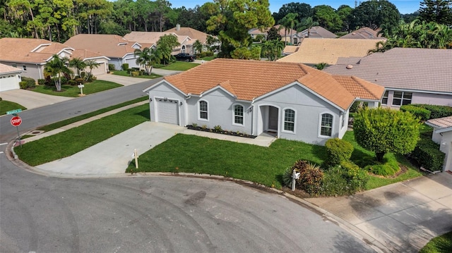 view of front facade with a front yard and a garage