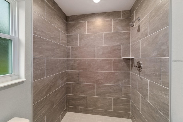 bathroom with tiled shower and toilet