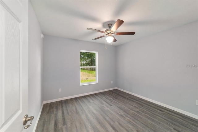 empty room featuring dark hardwood / wood-style floors and ceiling fan