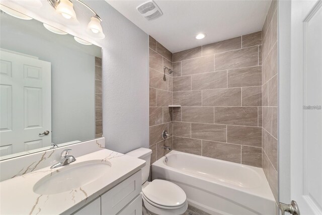 full bathroom with vanity, toilet, and tiled shower / bath