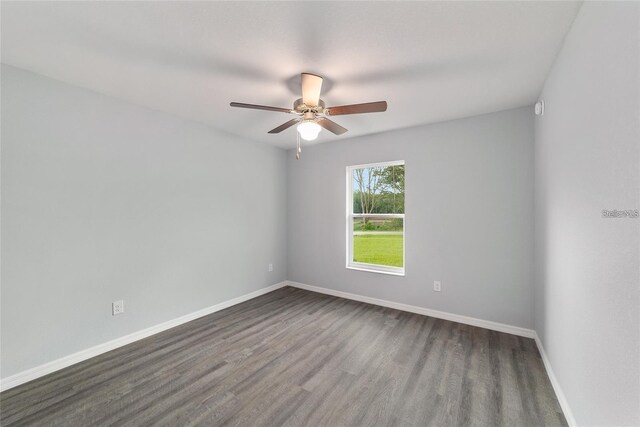 spare room featuring ceiling fan and dark hardwood / wood-style flooring