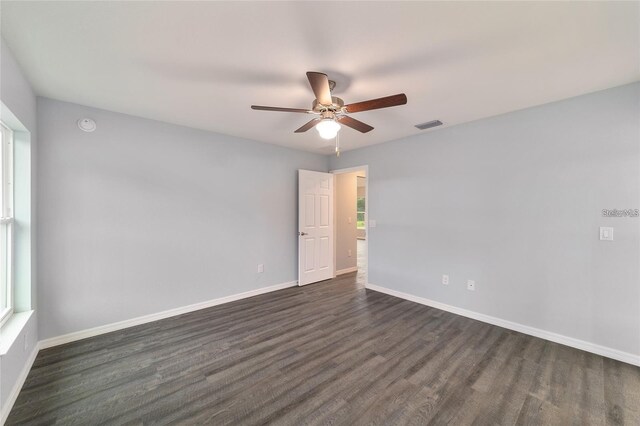 spare room with ceiling fan and dark hardwood / wood-style floors