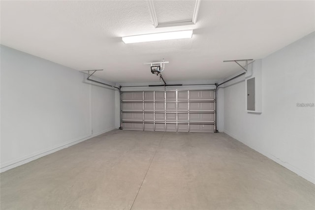 garage with a garage door opener and electric panel