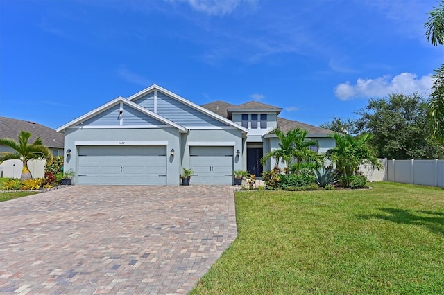 view of front of property featuring a front lawn and a garage