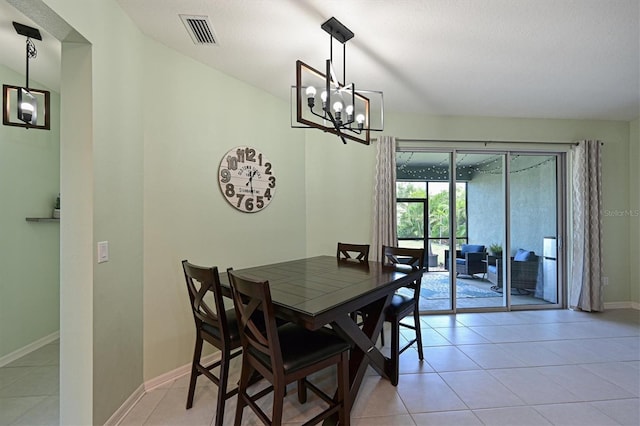 dining space with baseboards, visible vents, a notable chandelier, and light tile patterned floors