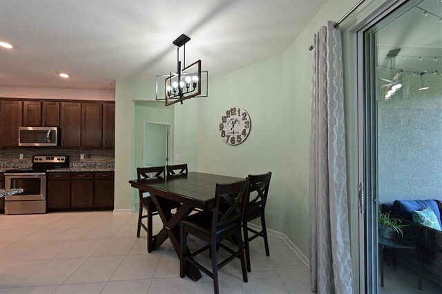 tiled dining space with a notable chandelier