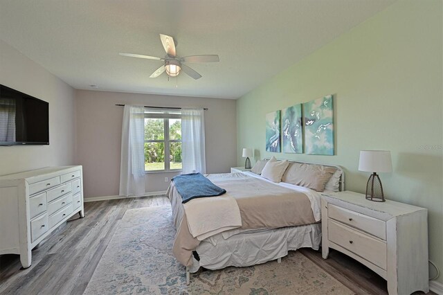 bedroom featuring light wood-type flooring and ceiling fan