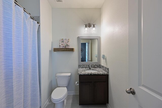 bathroom with curtained shower, vanity, toilet, and tile patterned floors